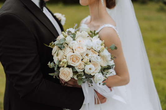 Elegant wedding floral arrangements with roses and greenery, designed for a romantic ceremony and reception